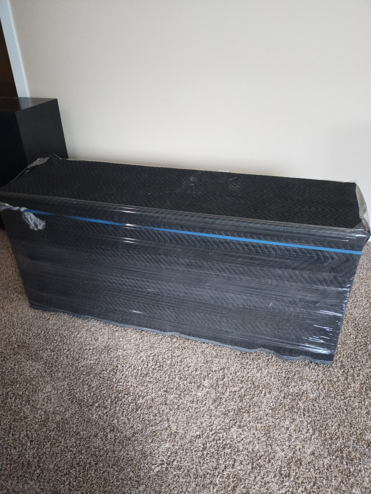 Furniture wrapped and protected with moving blankets